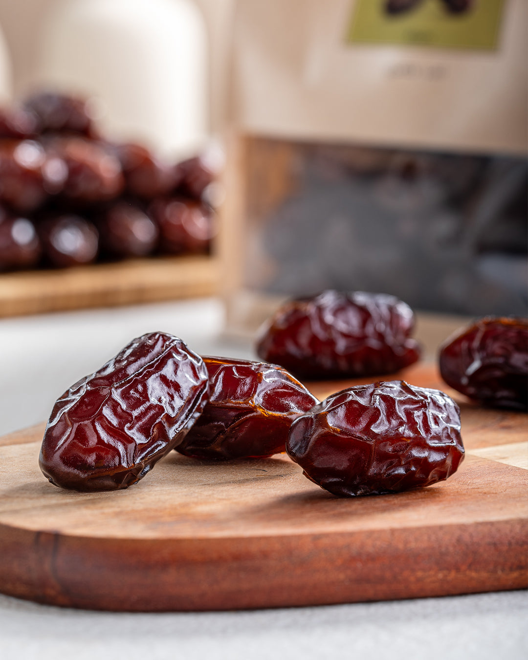 Khidri Date fruits on a wooden cutting board with a blurred background