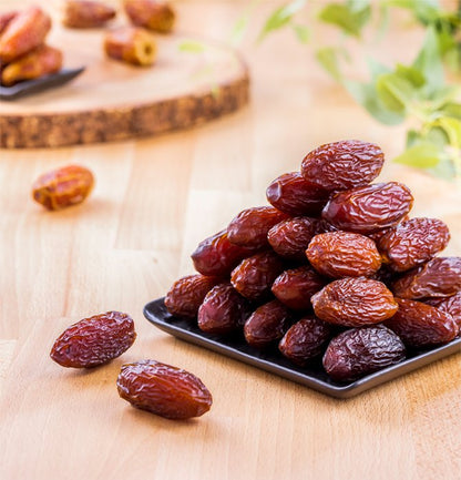Medjool Dates on a wooden surface with a blurred background